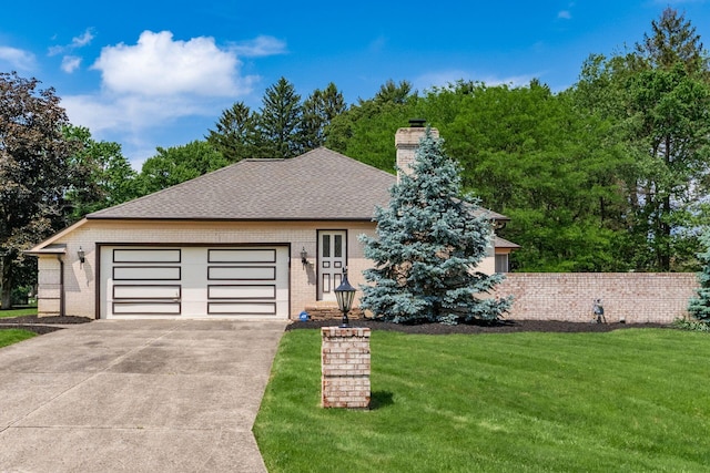 337 Naiche Ct, Columbus, OH 43213 - ranch-style house with brick siding, concrete driveway, a chimney, a front yard, and roof with shingles