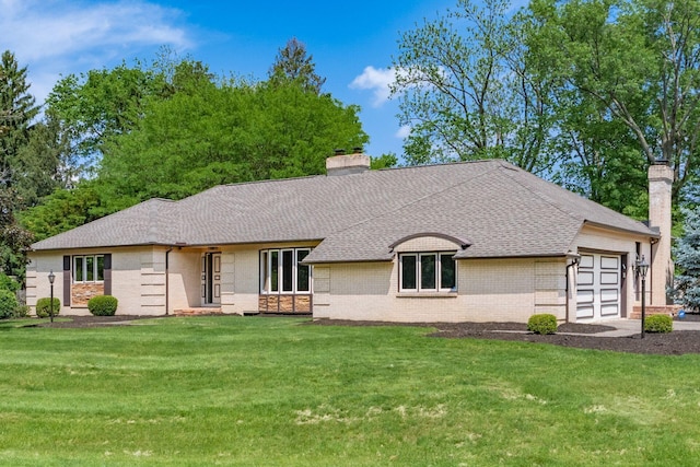 337 Naiche Ct, Columbus, OH 43213 - view of front of home featuring a chimney, brick siding, a garage, a front lawn, and roof with shingles