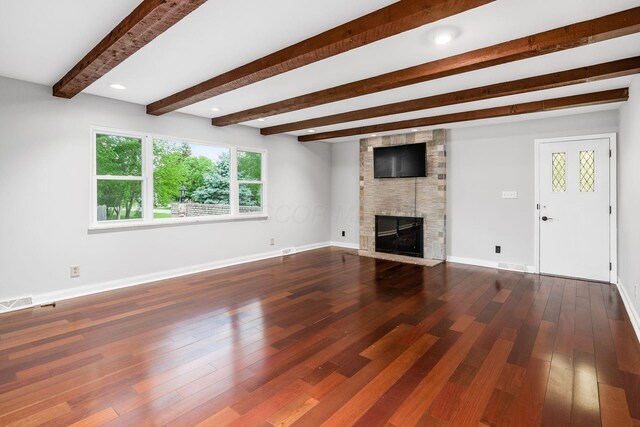 337 Naiche Ct, Columbus, OH 43213 - unfurnished living room with beamed ceiling, a fireplace, and wood finished floors