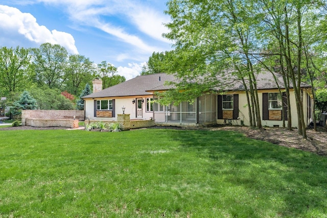 337 Naiche Ct, Columbus, OH 43213 - back of property featuring a chimney, a sunroom, a yard, and stucco siding