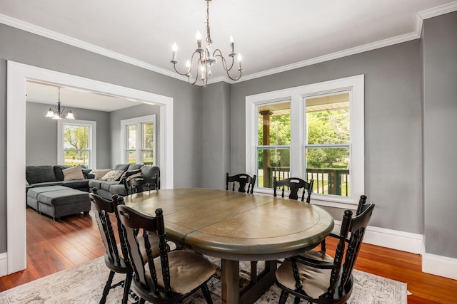 2174 Peachblow Rd, Lewis Center, OH 43035 - dining space featuring a chandelier, wood finished floors, crown molding, and baseboards