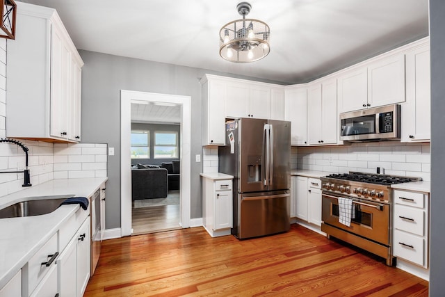 2174 Peachblow Rd, Lewis Center, OH 43035 - kitchen featuring stainless steel appliances, a sink, light countertops, and light wood-style flooring