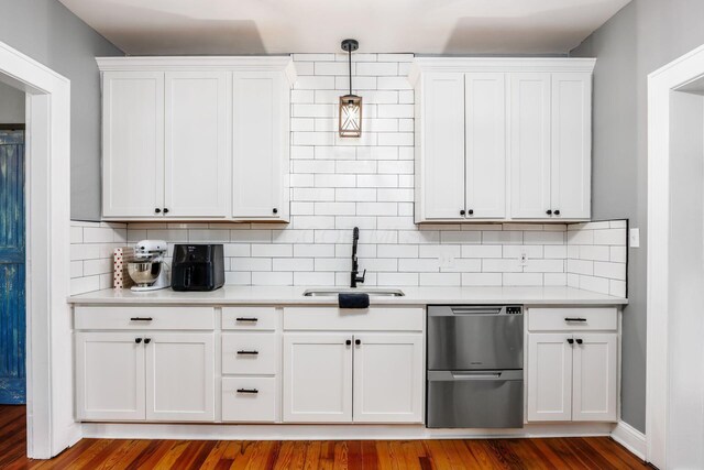 2174 Peachblow Rd, Lewis Center, OH 43035 - kitchen featuring a sink, dishwasher, light countertops, and white cabinets
