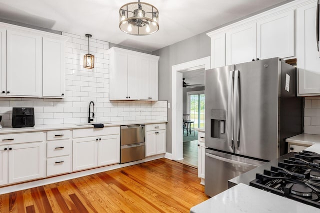 2174 Peachblow Rd, Lewis Center, OH 43035 - kitchen with stainless steel appliances, a sink, light countertops, and decorative backsplash