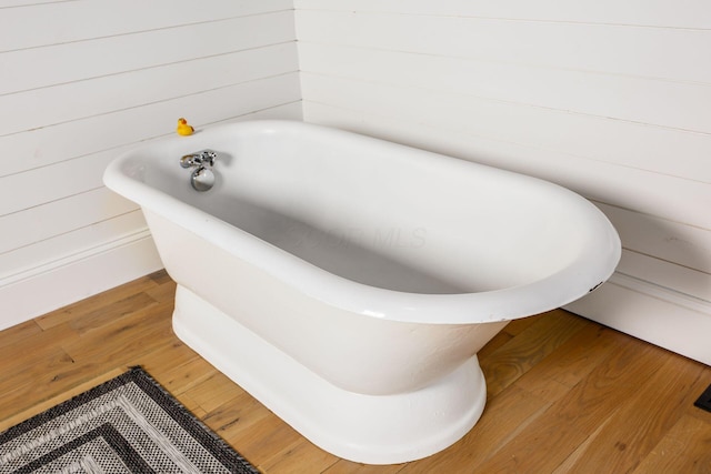 2174 Peachblow Rd, Lewis Center, OH 43035 - bathroom featuring a freestanding bath and wood finished floors