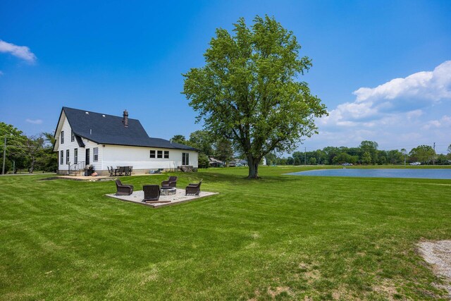 2174 Peachblow Rd, Lewis Center, OH 43035 - view of grassy yard featuring a fire pit, a water view, and a patio area