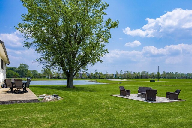 2174 Peachblow Rd, Lewis Center, OH 43035 - view of grassy yard featuring a patio area, a water view, and a fire pit