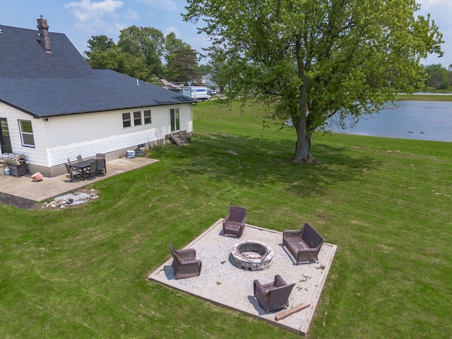 2174 Peachblow Rd, Lewis Center, OH 43035 - view of green lawn featuring an outdoor fire pit, entry steps, a patio area, and a water view