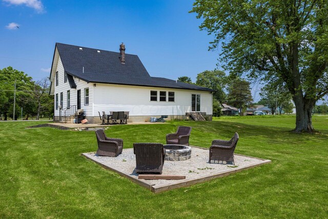 2174 Peachblow Rd, Lewis Center, OH 43035 - rear view of property featuring a fire pit, entry steps, a lawn, a patio, and a chimney
