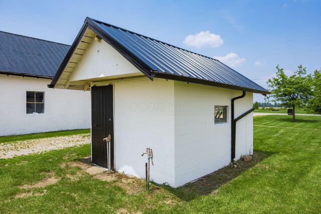 2174 Peachblow Rd, Lewis Center, OH 43035 - view of side of home featuring metal roof, a yard, an outdoor structure, and concrete block siding