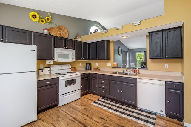 5191 Upland Meadow Dr, Canal Winchester, OH 43110 - kitchen featuring white appliances, a sink, vaulted ceiling, light wood-style floors, and light countertops