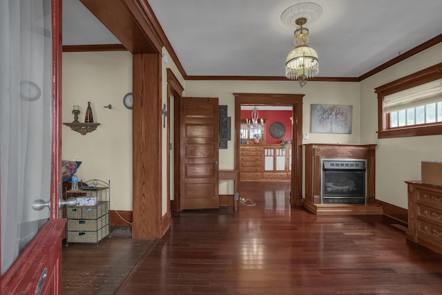 132 Orange St, Galion, OH 44833 - entryway featuring wood-type flooring, a glass covered fireplace, a chandelier, and crown molding