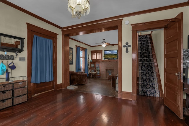 132 Orange St, Galion, OH 44833 - entryway with wood finished floors, ornamental molding, a fireplace, a chandelier, and baseboards