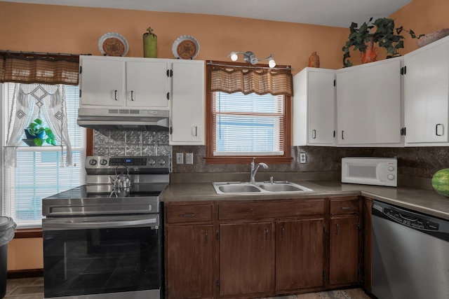 132 Orange St, Galion, OH 44833 - kitchen with stainless steel appliances, under cabinet range hood, a sink, backsplash, and white cabinets