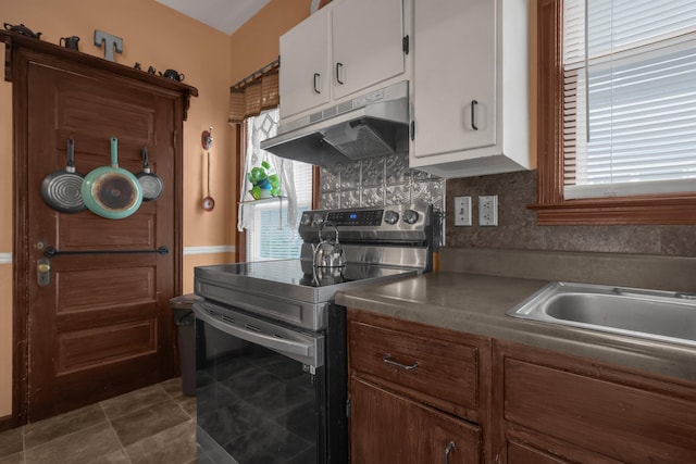 132 Orange St, Galion, OH 44833 - kitchen featuring stainless steel electric range oven, under cabinet range hood, healthy amount of natural light, and white cabinets