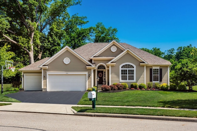340 Olentangy W, Delaware, OH 43015 - view of front facade featuring a garage, driveway, a front yard, and a shingled roof