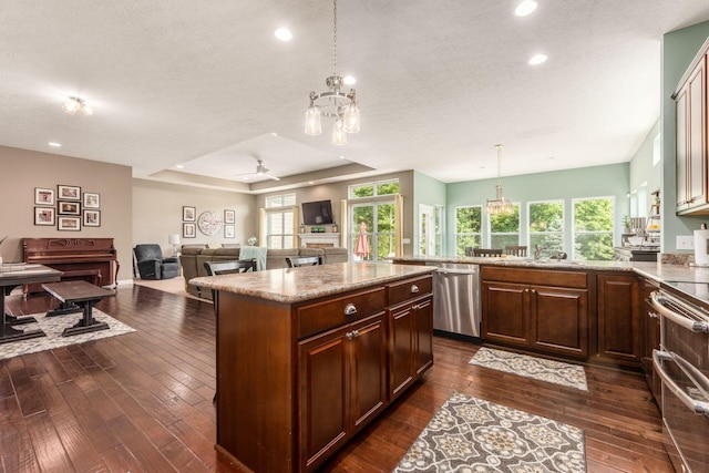 340 Olentangy W, Delaware, OH 43015 - kitchen featuring stainless steel appliances, dark wood finished floors, a tray ceiling, open floor plan, and a peninsula