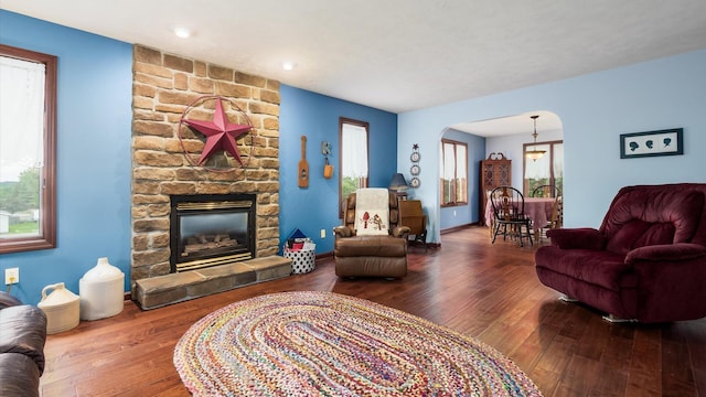 102 Sequoia Dr, Byesville, OH 43723 - living room with arched walkways, hardwood / wood-style flooring, and a fireplace