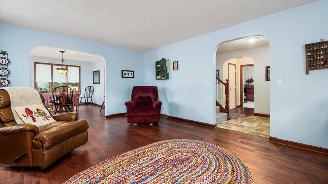 102 Sequoia Dr, Byesville, OH 43723 - living area with arched walkways, wood finished floors, stairway, and baseboards