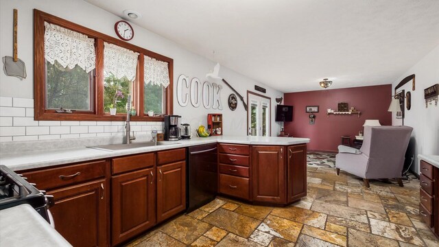 102 Sequoia Dr, Byesville, OH 43723 - kitchen with black appliances, light countertops, a sink, a peninsula, and stone tile floors
