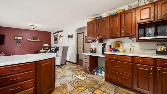 102 Sequoia Dr, Byesville, OH 43723 - kitchen with stone tile floors, light countertops, and arched walkways