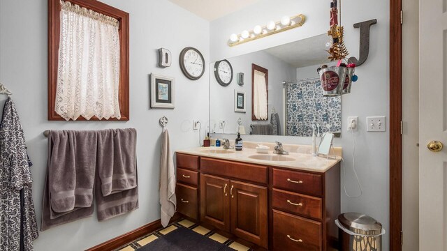 102 Sequoia Dr, Byesville, OH 43723 - bathroom featuring double vanity and baseboards