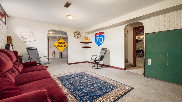 102 Sequoia Dr, Byesville, OH 43723 - living area featuring arched walkways, tile patterned flooring, and stairway