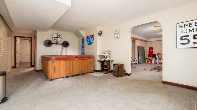 102 Sequoia Dr, Byesville, OH 43723 - bar area with arched walkways, light tile patterned floors, baseboards, and brick wall