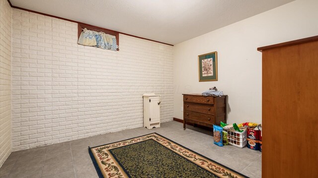 102 Sequoia Dr, Byesville, OH 43723 - game room featuring brick wall and tile patterned floors