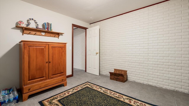 102 Sequoia Dr, Byesville, OH 43723 - bedroom with brick wall and tile patterned floors