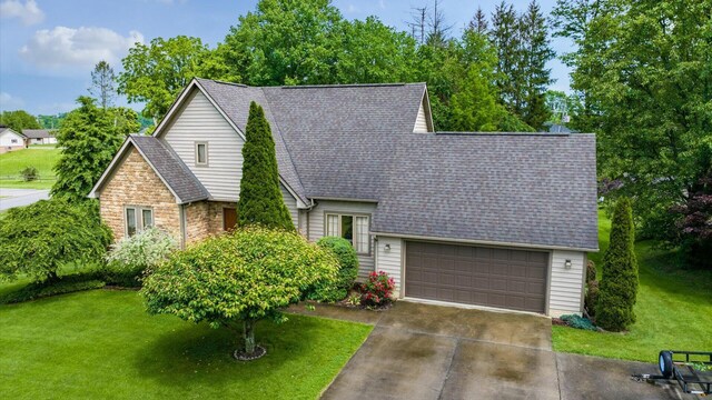 102 Sequoia Dr, Byesville, OH 43723 - view of front of house featuring stone siding, an attached garage, a front yard, and a shingled roof