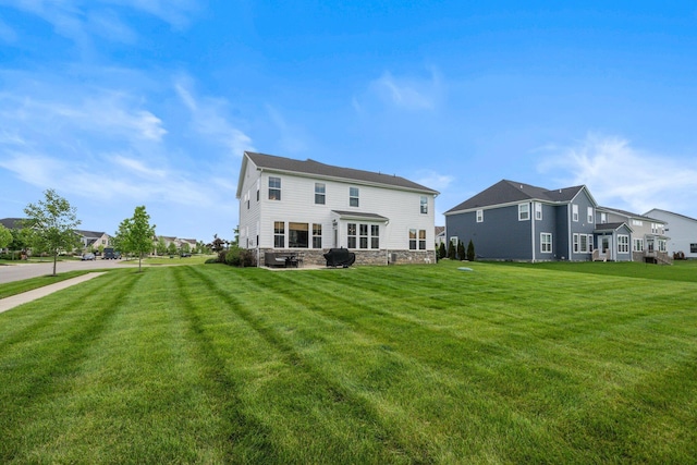 8318 Fig Grove Way, Plain City, OH 43064 - rear view of property featuring a yard, stone siding, and a residential view