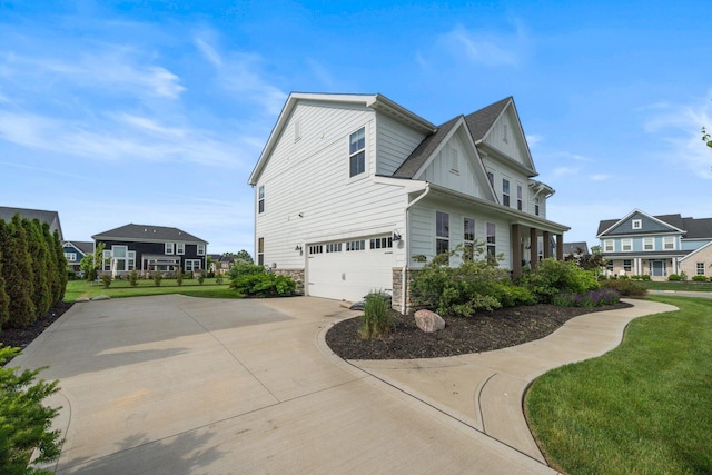 8318 Fig Grove Way, Plain City, OH 43064 - view of side of home featuring an attached garage, driveway, stone siding, and a lawn