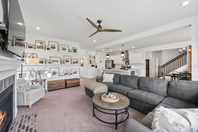 8318 Fig Grove Way, Plain City, OH 43064 - living room with a warm lit fireplace, stairway, a ceiling fan, carpet flooring, and recessed lighting