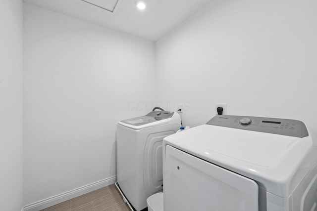 8318 Fig Grove Way, Plain City, OH 43064 - laundry area featuring washing machine and dryer, baseboards, light wood-type flooring, and recessed lighting