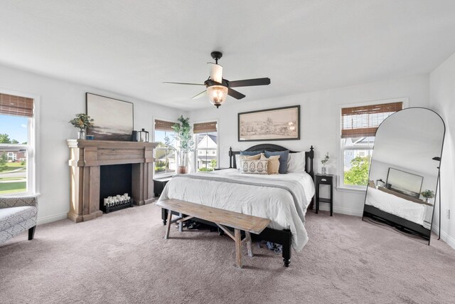 8318 Fig Grove Way, Plain City, OH 43064 - carpeted bedroom featuring multiple windows, a fireplace, a ceiling fan, and baseboards