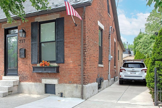 717 S 3rd St, Columbus, OH 43206 - view of side of home featuring brick siding and entry steps