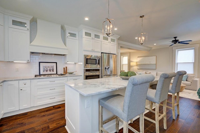 717 S 3rd St, Columbus, OH 43206 - kitchen featuring appliances with stainless steel finishes, premium range hood, open floor plan, plenty of natural light, and recessed lighting