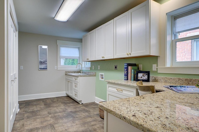 717 S 3rd St, Columbus, OH 43206 - kitchen featuring white cabinets and light stone countertops