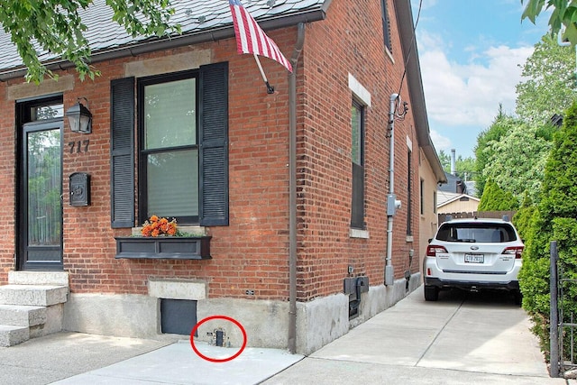 717 S 3rd St, Columbus, OH 43206 - view of side of home featuring brick siding and entry steps