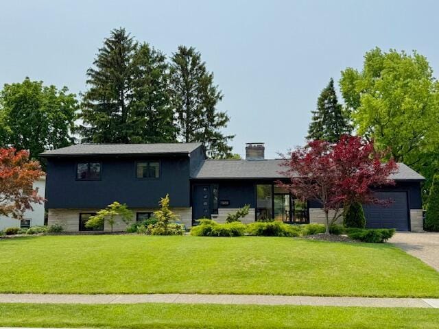 1805 Millwood Dr, Columbus, OH 43221 - split level home with a garage, a front lawn, driveway, and a chimney