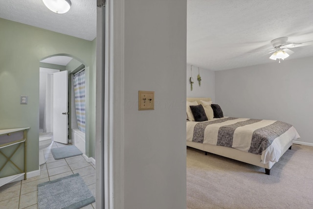 1442 S 4th St, Columbus, OH 43207 - bedroom featuring arched walkways, a textured ceiling, baseboards, light tile patterned flooring, and ceiling fan