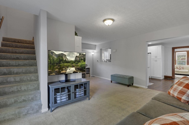 1442 S 4th St, Columbus, OH 43207 - living room featuring stairs, carpet floors, baseboards, and a textured ceiling