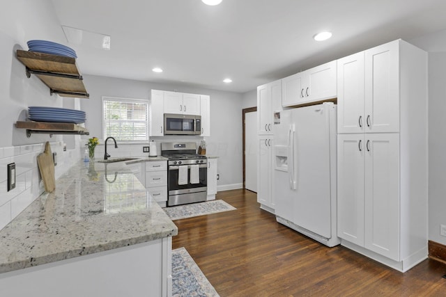 1442 S 4th St, Columbus, OH 43207 - kitchen featuring stainless steel appliances, open shelves, white cabinetry, light stone counters, and tasteful backsplash