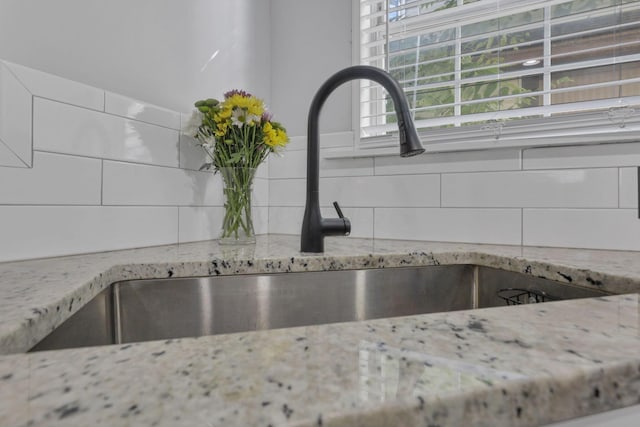 1442 S 4th St, Columbus, OH 43207 - kitchen view of backsplash, light stone countertops, and a sink
