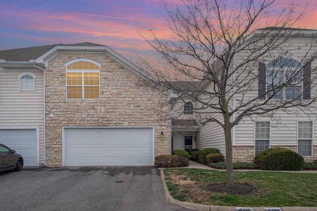 5145 Vinings Blvd Unit B, Dublin, OH 43016 - view of front facade featuring stone siding, asphalt driveway, and a garage