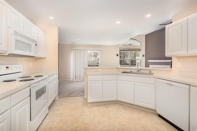5145 Vinings Blvd Unit B, Dublin, OH 43016 - kitchen featuring white appliances, a sink, light countertops, white cabinetry, and a peninsula