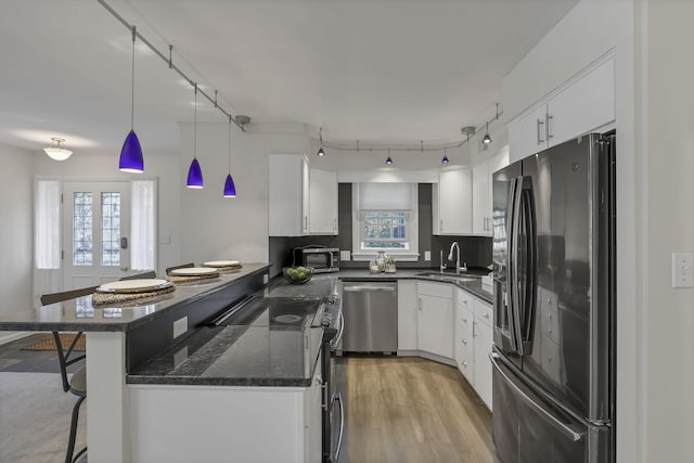 1631 Roxbury Rd Unit B6, Columbus, OH 43212 - kitchen with fridge with ice dispenser, stainless steel dishwasher, a sink, a kitchen bar, and a peninsula