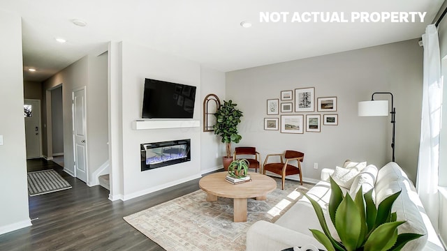 1420 Chrisman Dr, Columbus, OH 43223 - living area featuring dark wood-style floors, a glass covered fireplace, baseboards, and recessed lighting