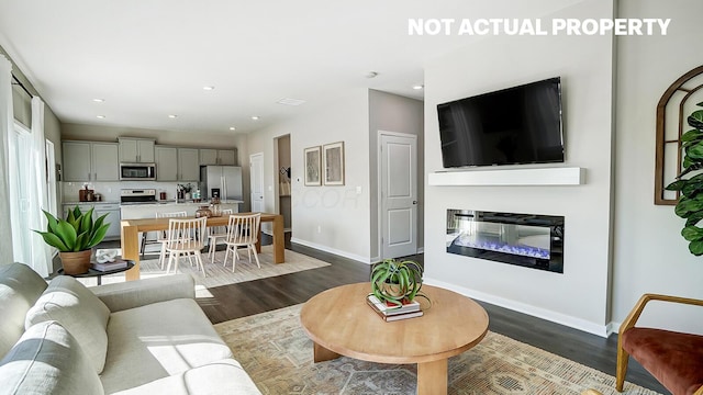 1420 Chrisman Dr, Columbus, OH 43223 - living room with dark wood-type flooring, baseboards, a glass covered fireplace, and recessed lighting